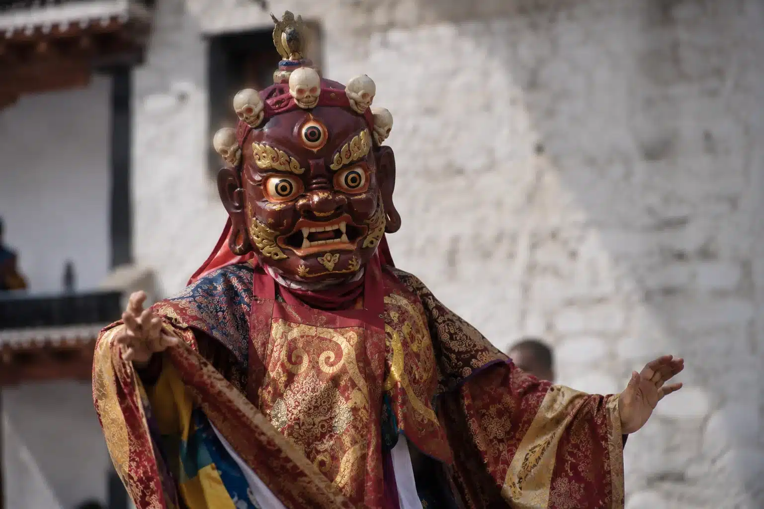 Buddhist monk in Cham Dance mask and silk robes at Hemis Festival Ladakh
