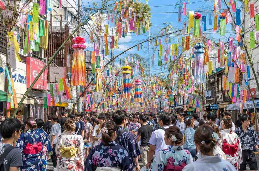 Colorful tanabata decorations hanging on bamboo branches at a Japanese festival