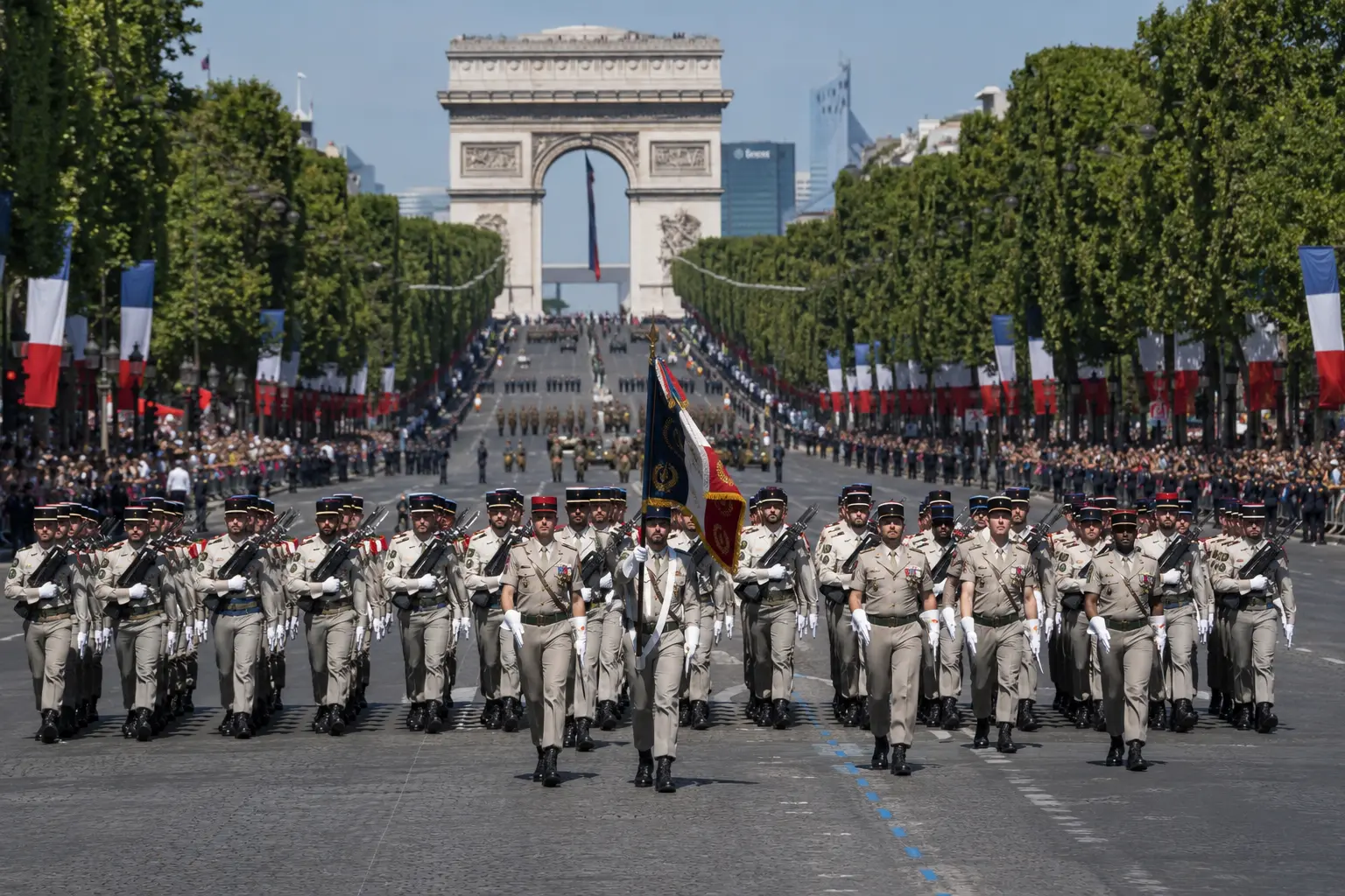 Bastille Day 2026 military parade marching past the Arc de Triomphe on the Champs-Élysées
