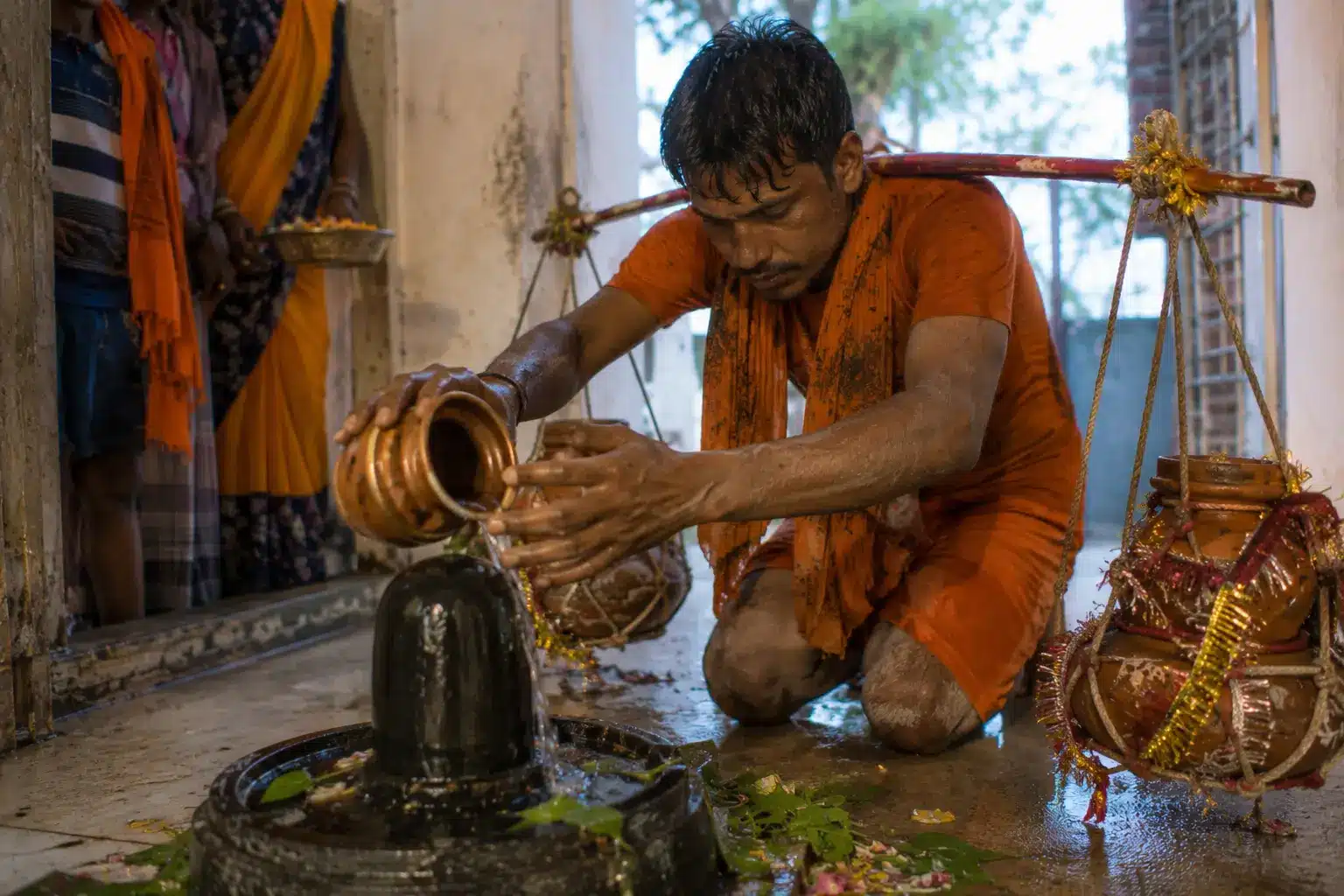  Exhausted Kanwariya performing jalabhishek at a local temple after completing Kanwar Yatra 2026