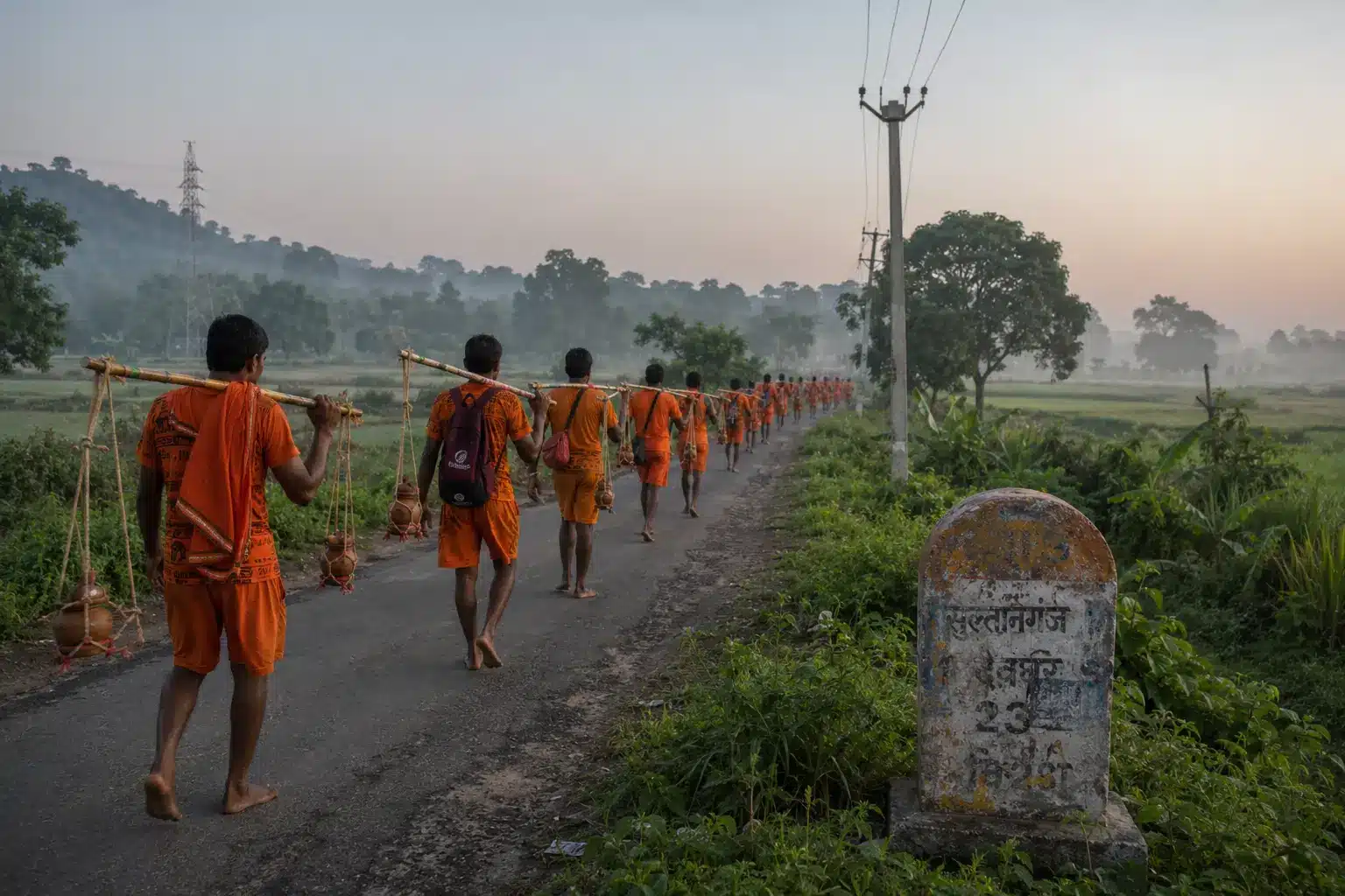 Kanwariyas walking the quiet Sultanganj-Deoghar route during Kanwar Yatra 2026 in rural Bihar