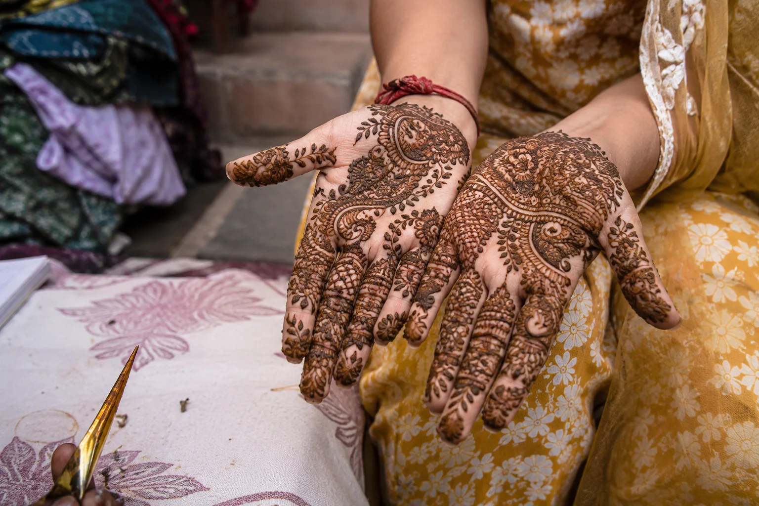 Freshly applied Rajasthani mehndi on woman's hands during Teej festival in Jaipur