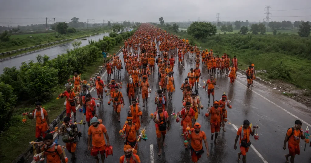 Aerial view of millions of saffron-clad Kanwar Yatra Impacts pilgrims walking on North India highway