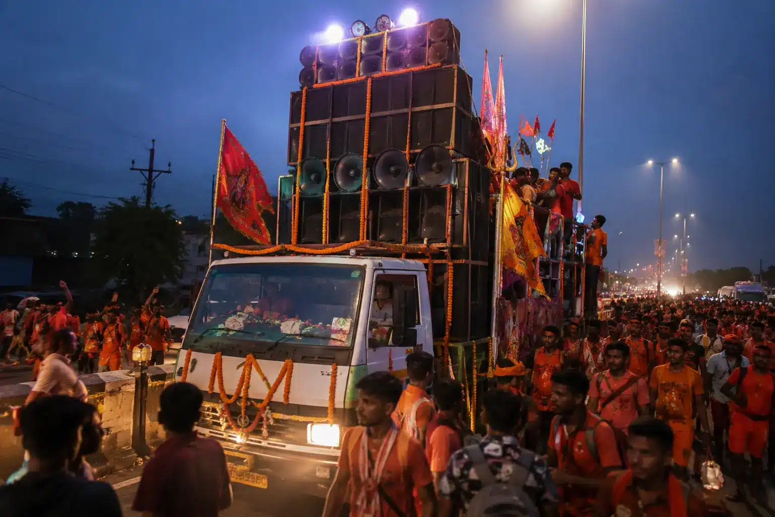 DJ truck with massive speakers surrounded by Kanwar Yatra 2026 pilgrims causing noise pollution