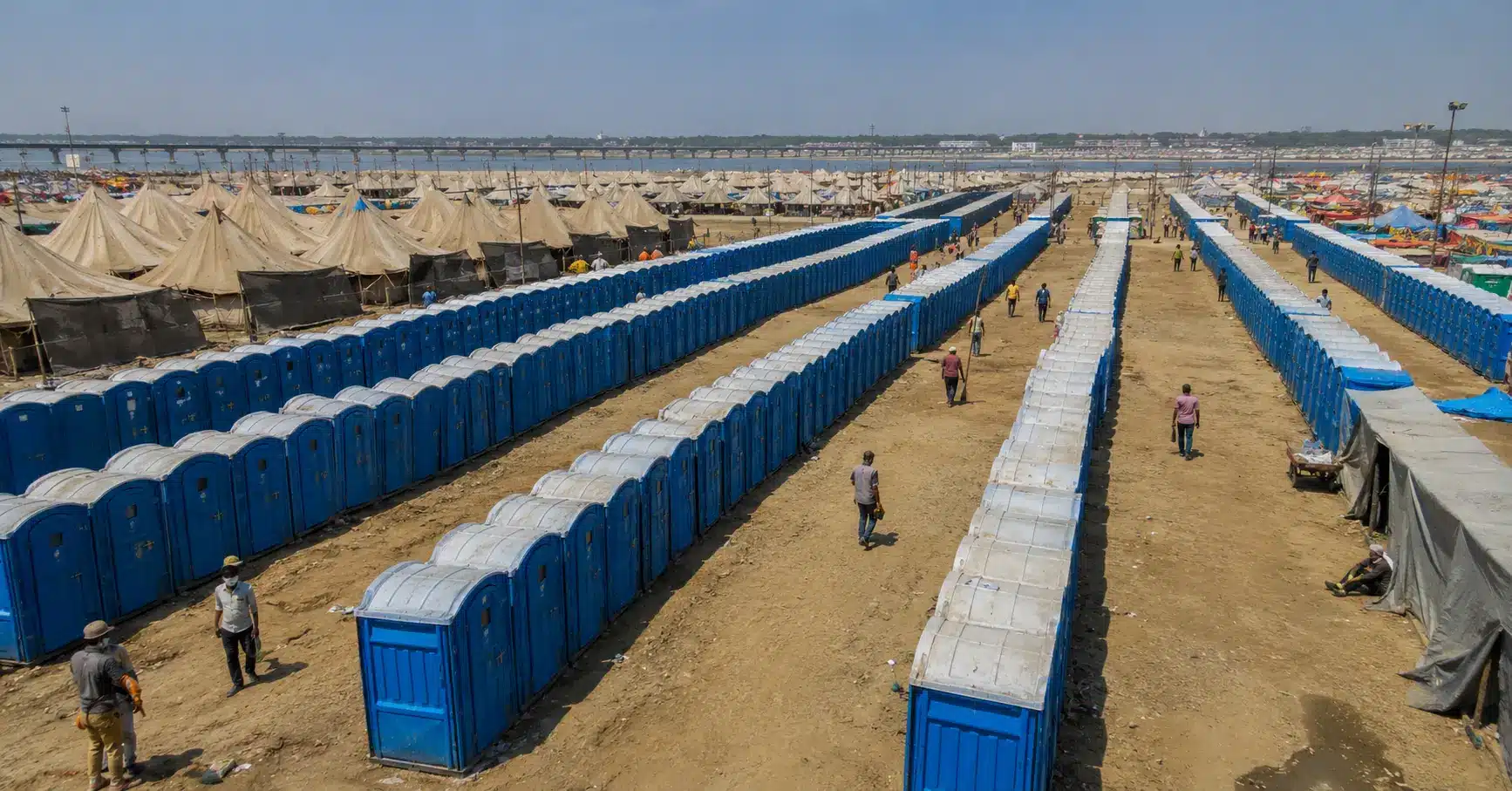 Rows of temporary sanitation cabins built for a large religious river gathering