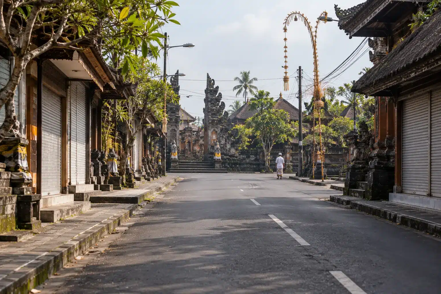 Empty street in Bali on Nyepi, with closed shop shutters and no traffic