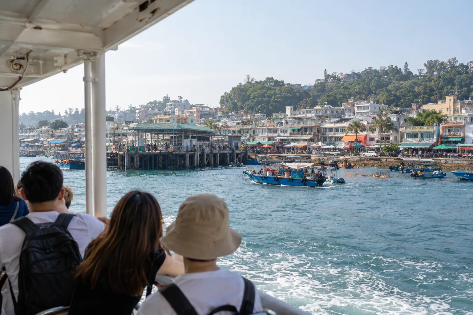 Cheung Chau waterfront and harbour seen from an arriving ferry, with low-rise buildings along the shore