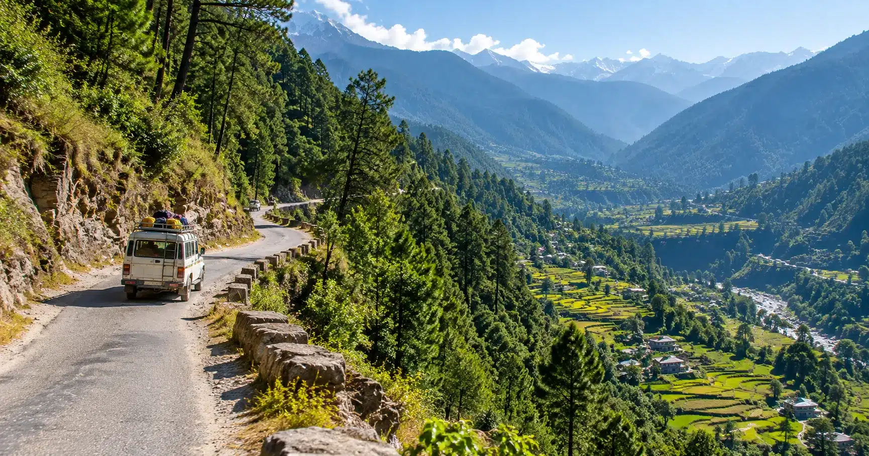 A mountain road winding toward Uttarakhand's Sor Valley through forested Himalayan terrain