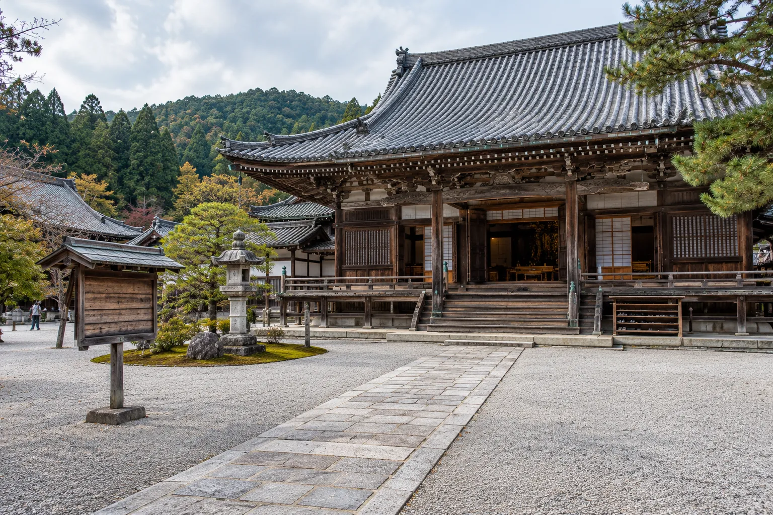 Japanese temple compound with annotated photography rules for the grounds, notice board, shoe shelf and main hall